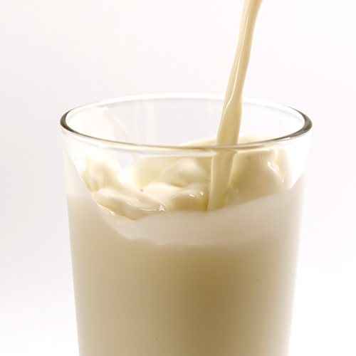 Pouring protein powder into a glass of water