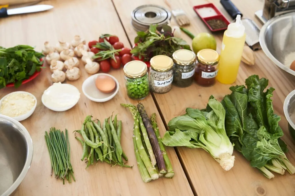 Fresh green vegetables arranged on a wooden table
