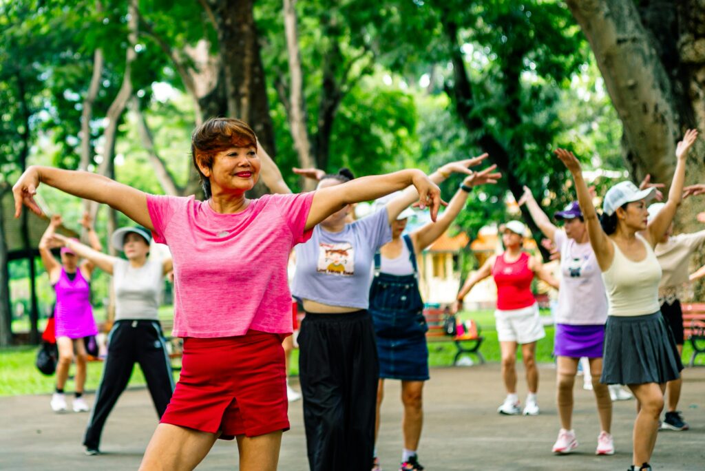 Women exercising together outdoors in a park