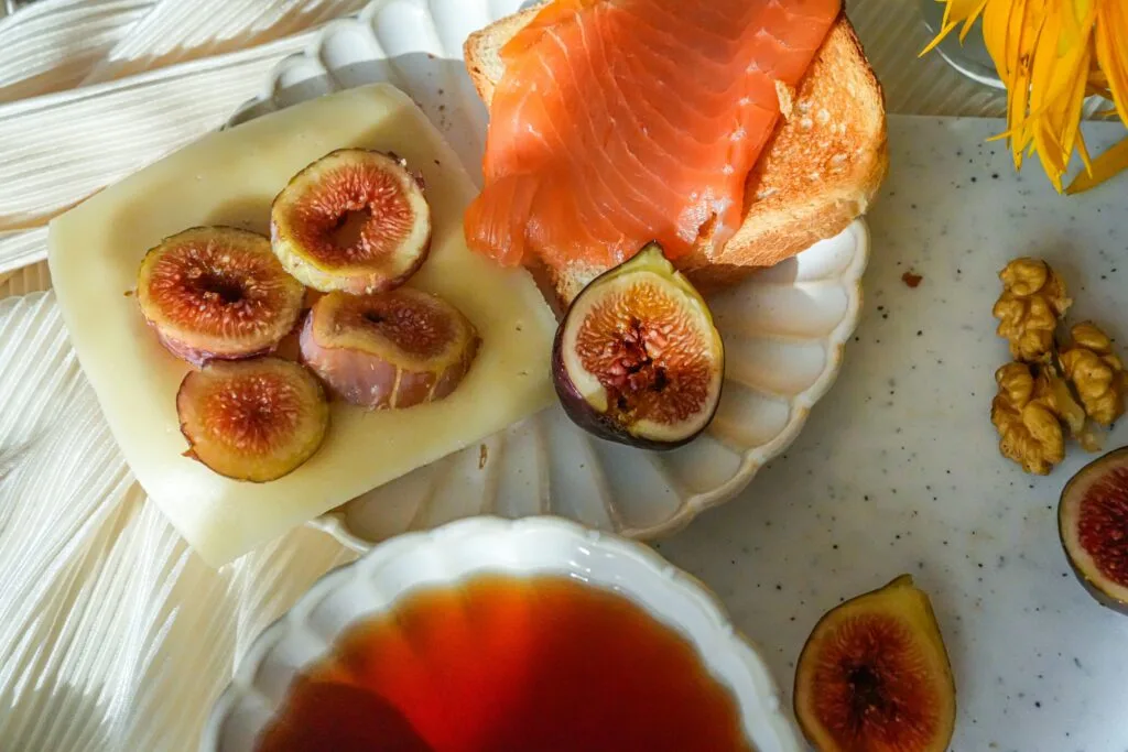 Healthy food spread with salmon, figs, cheese and walnuts on a table