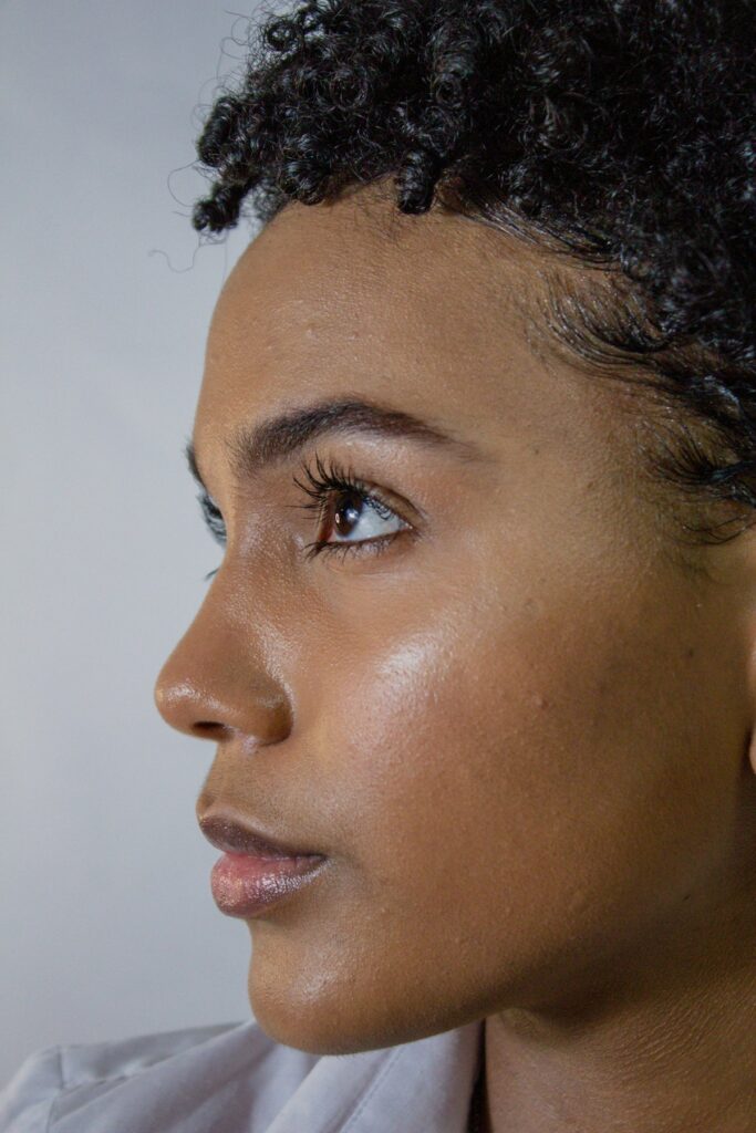 Woman with naturally healthy, glowing skin in soft natural light