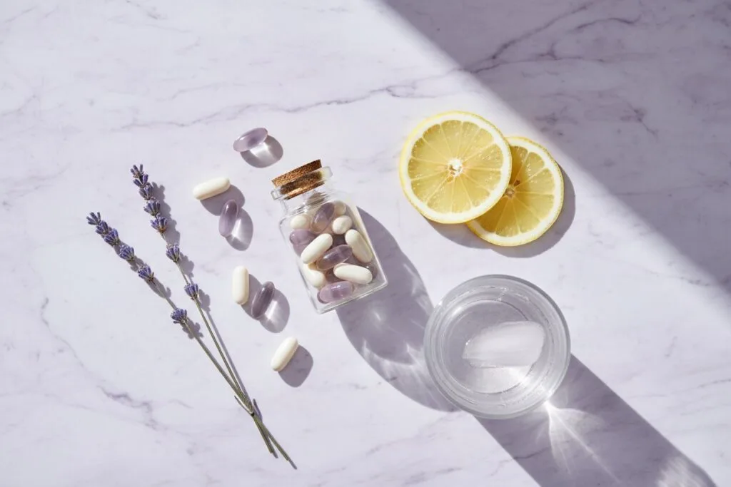 Flat lay of wellness supplements with lemon and lavender on marble — EP Supplements