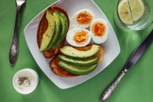 Open avocado sandwiches with poached eggs, a high protein breakfast idea