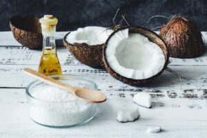 Raw coconut products including coconut flakes and coconut oil, the source of MCT oil