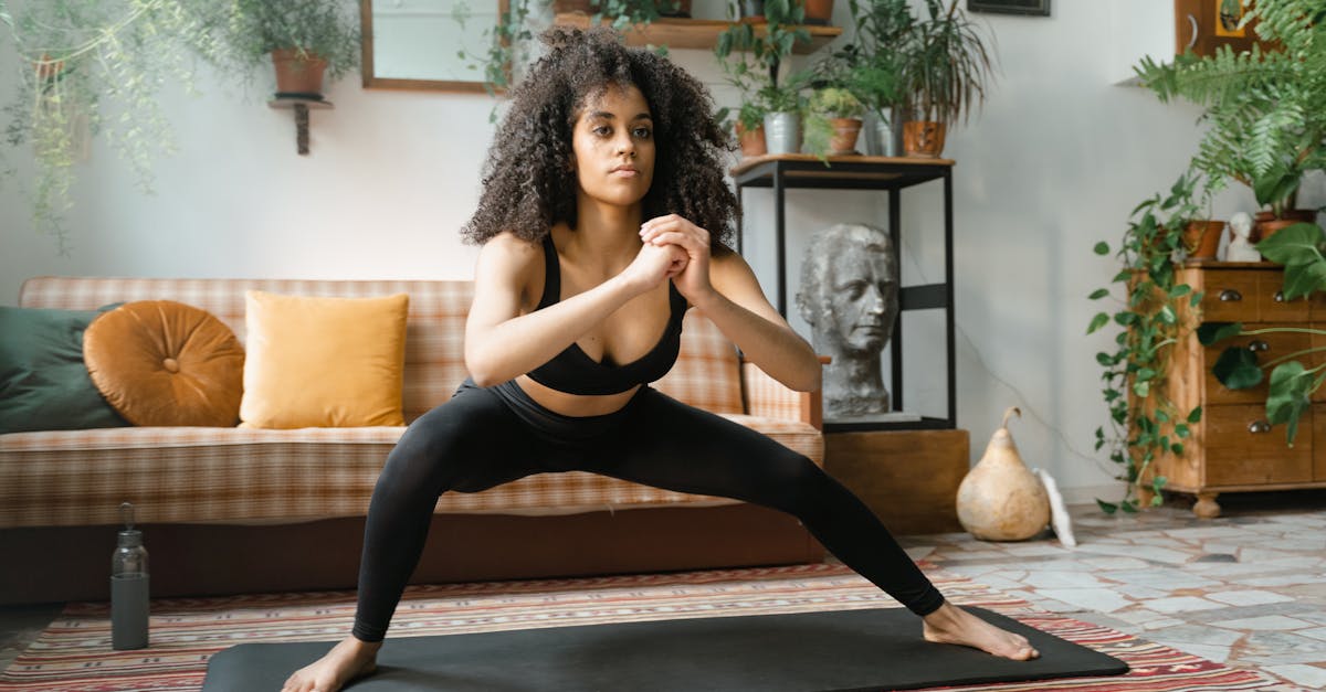 Woman exercising on a yoga mat at home — workout recovery and muscle growth