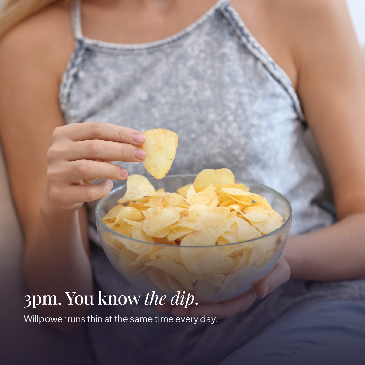 Woman eating crisps from a bowl in the afternoon — 3pm, you know the dip