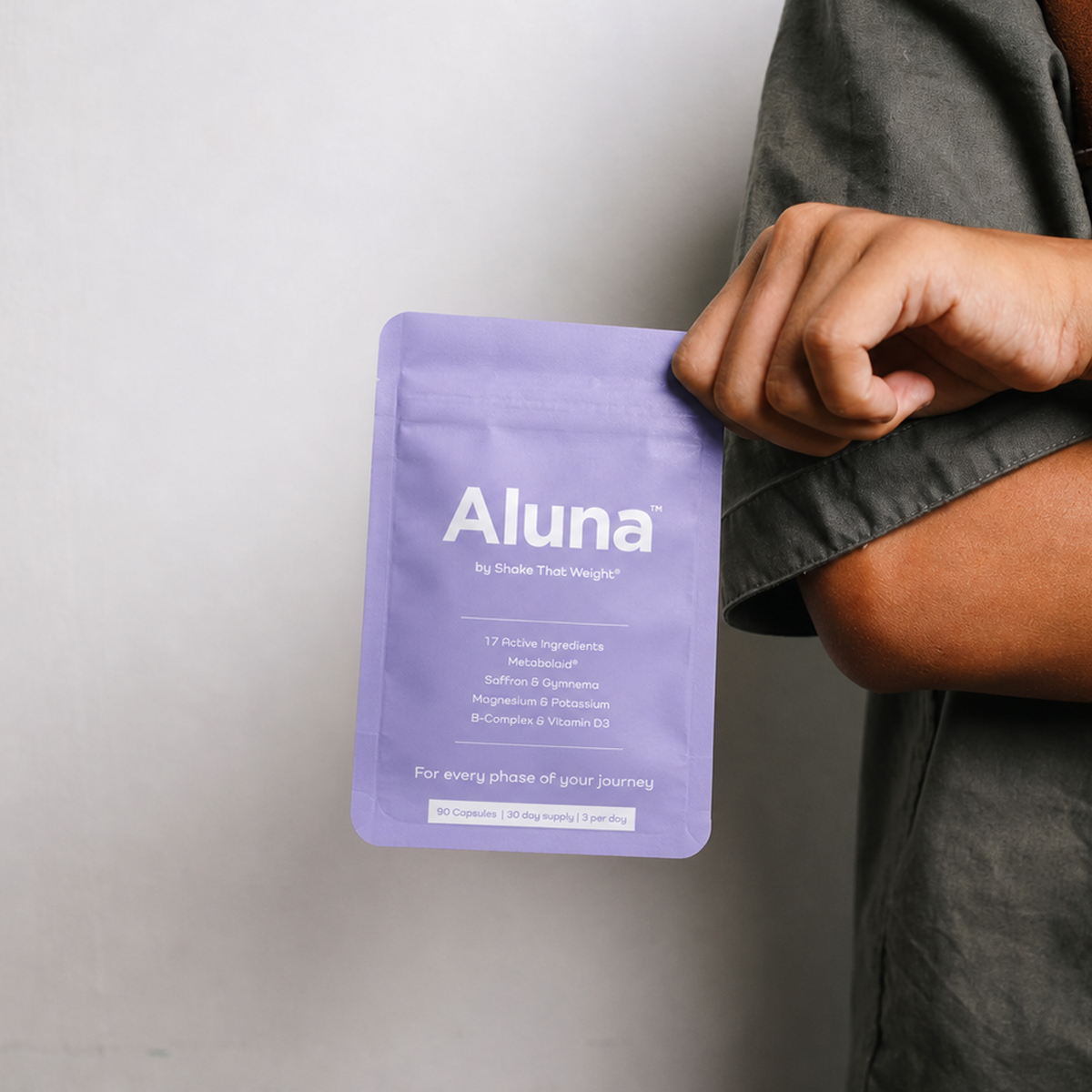 Hand holding an Aluna pouch by Shake That Weight