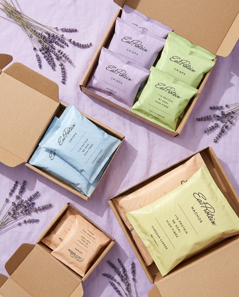 EatProtein protein crisp packs in kraft boxes of different sizes on a lilac background